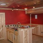 FINISHED PART OF BASEMENT IN THIS LAKE SIDE HOME TO CREATE A "MAN CAVE".  VERY UPSCALE--GRANITE COUNTER TOP, TILE FLOOR, FLAT SCREEN TV AND MODERN LIGHTING.